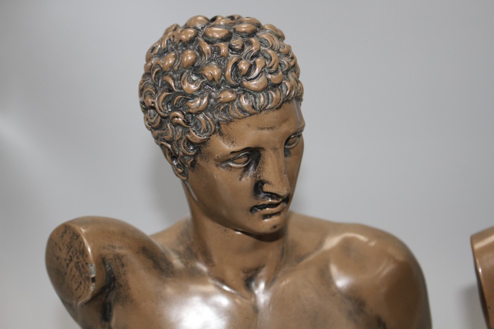 A pair of bronzed resin busts of Diana and Apollo, on integral bases, height 30cm